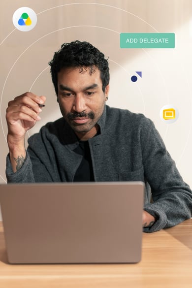 A man with a mustache looks at a laptop screen