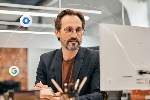 Professional man looks at a computer screen in a modern office setting