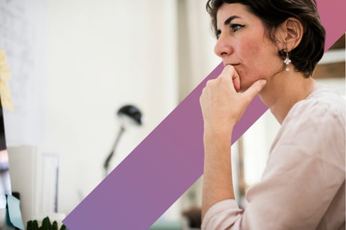 Professional woman looks at a computer screen in a modern office setting 
