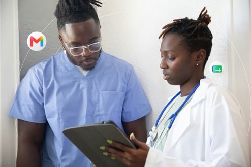 A doctor and nurse review patient data