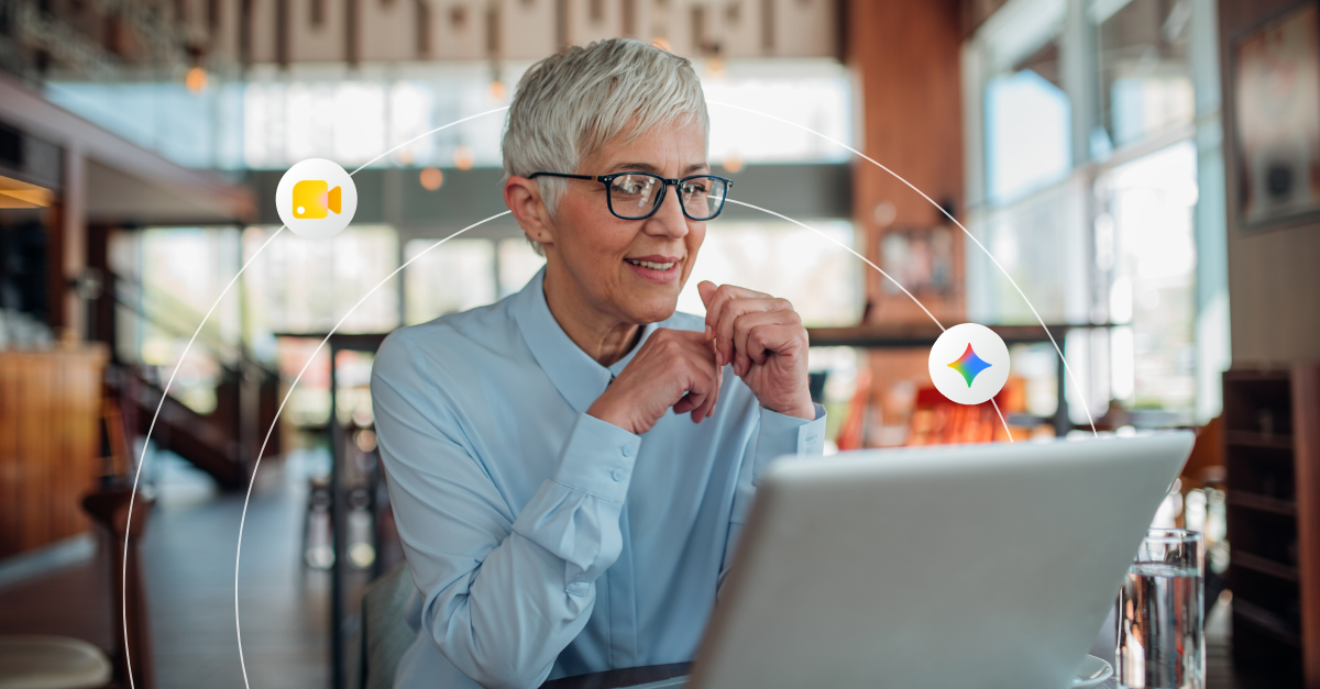 An older, professional woman works from a laptop in a cafe setting 