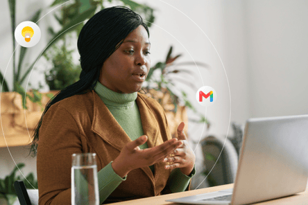 A young woman talks during a video call on her laptop